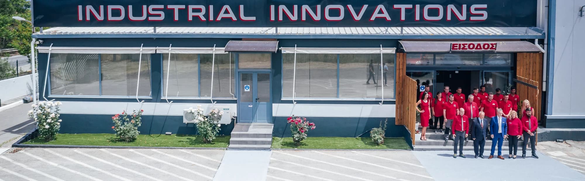 The Industrial Innovations facility frontage with the team in front of the entrance.