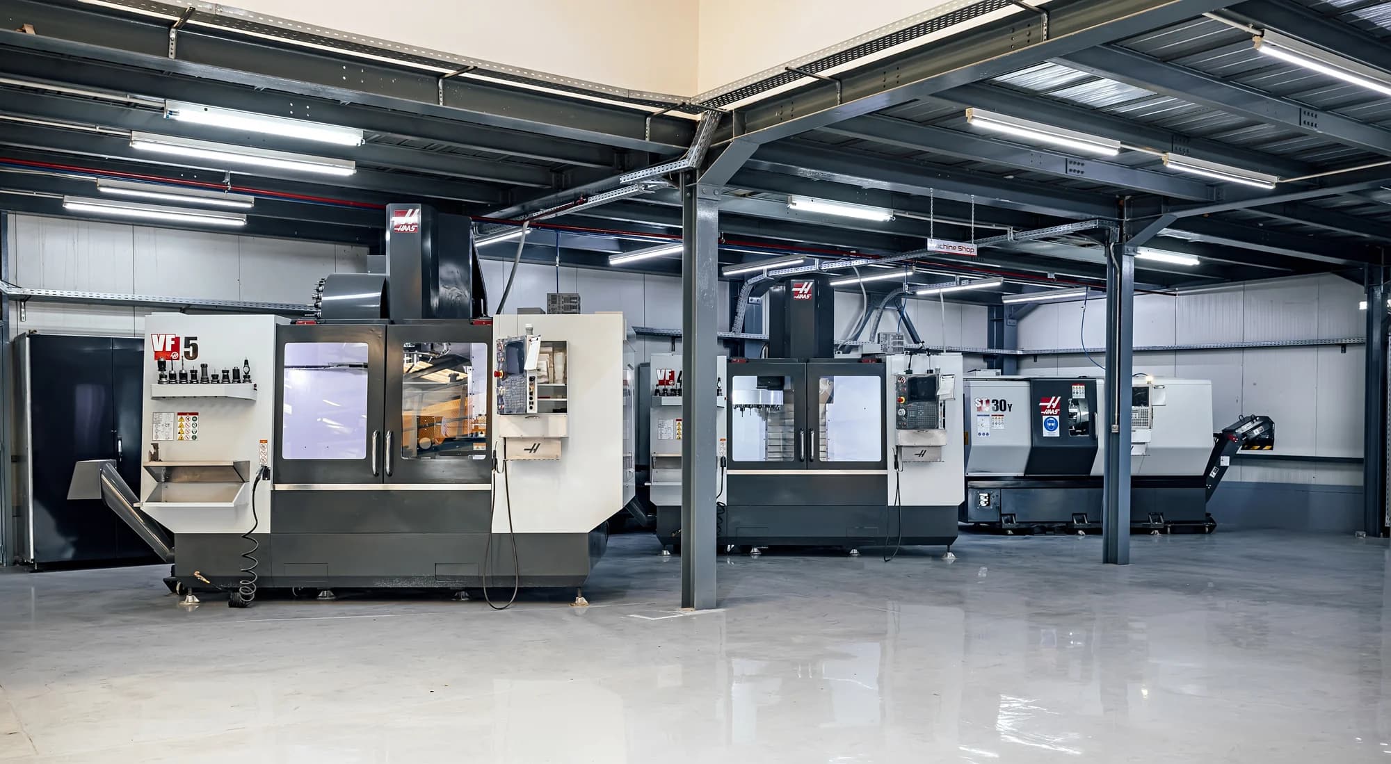 Machining hall with a row of CNC centres in one open industrial space.